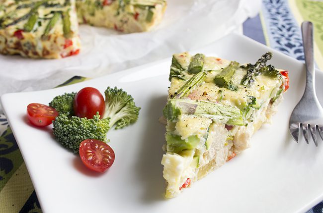 image of slice of chicken broccoli and red pepper frittata