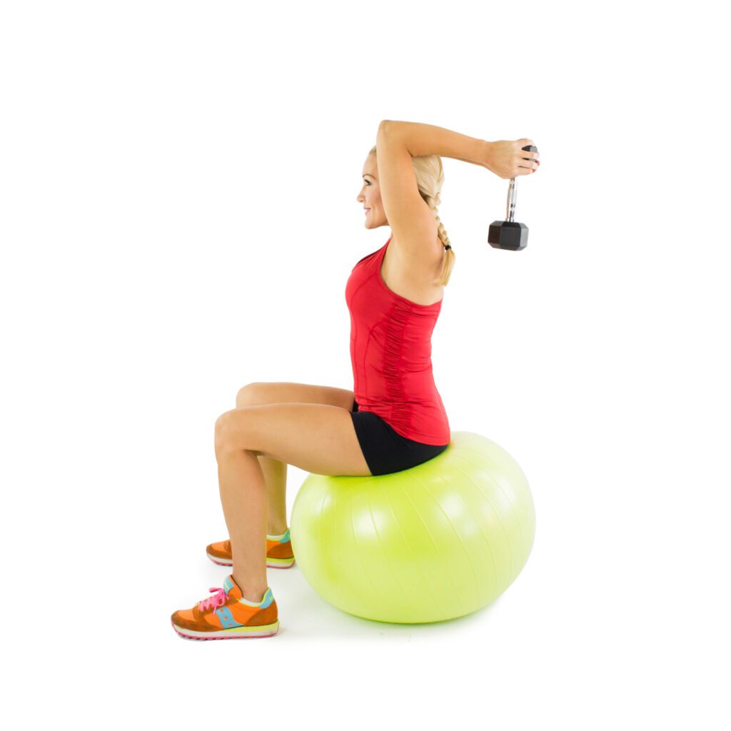image of Brooke doing dumbbell tricep extension on stability ball