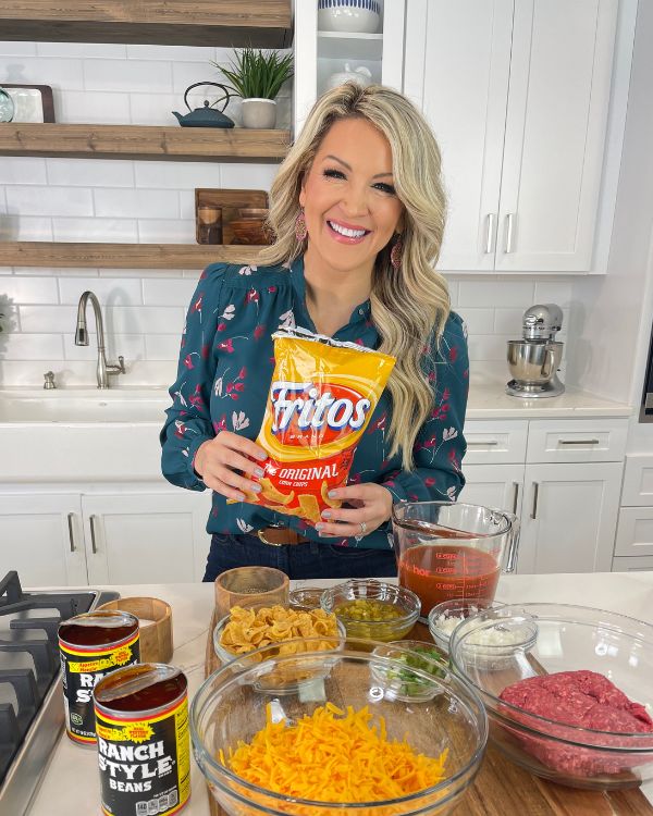 Easy Frito Pie ingredients with Brooke Farmer holding bag of Fritos