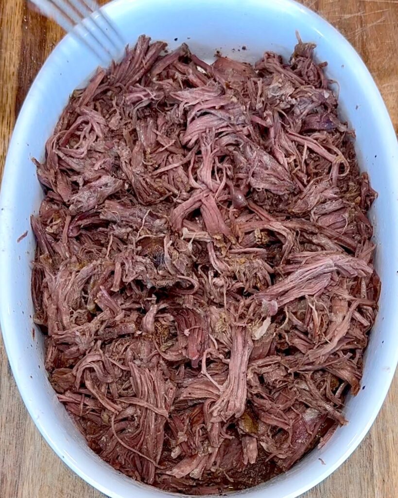 slow cooker southern pot roast recipe shredded and served with gravy
